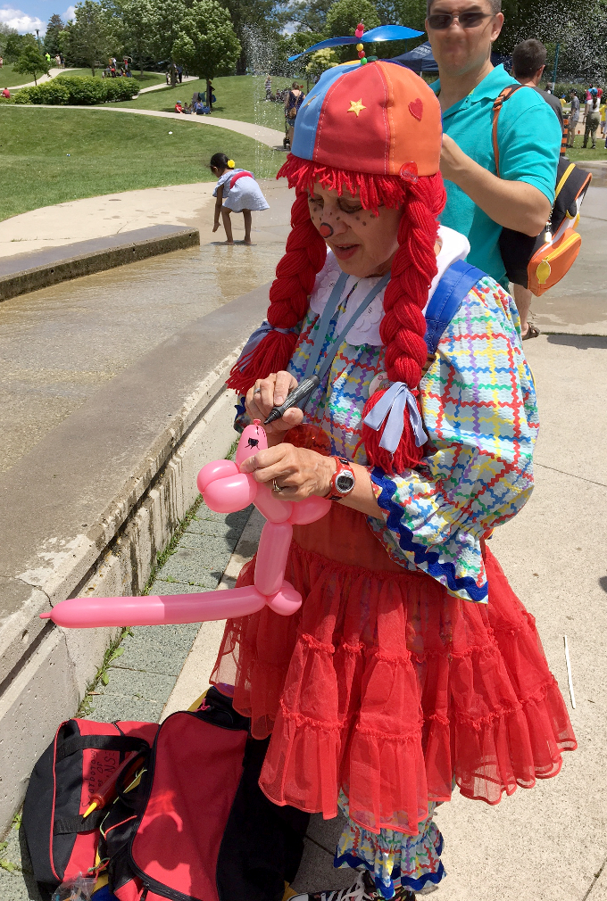2017 Port Union Waterfront festival, Scarborough Corp of Clowns, Tripper does a balloon pink dog with a long tail. How cute is that?