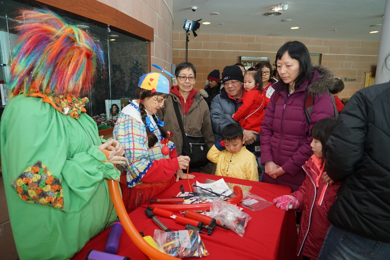2019 Chinese New Year, Markham Civic Center, Feb 10, 2019, sponsored by the Federation of Chinese Canadians in Markham. Scarborough Corp of Clowns, Jill and Tripper. Kids and parents line up for balloons. This little boy cannot decide on which balloon! Photo: FCCM